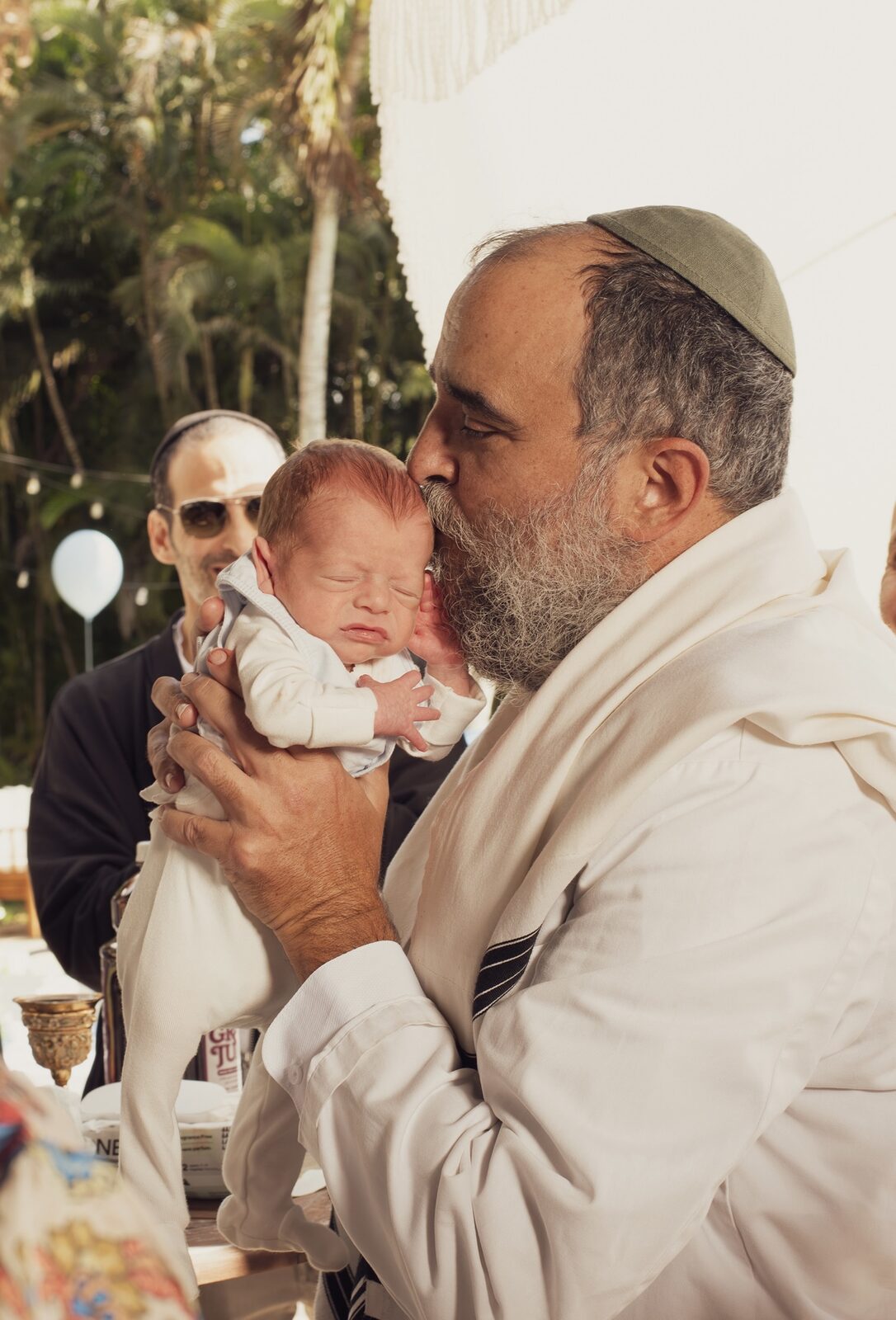 El Rabino Yossi besando con ternura la cabeza de un recién nacido